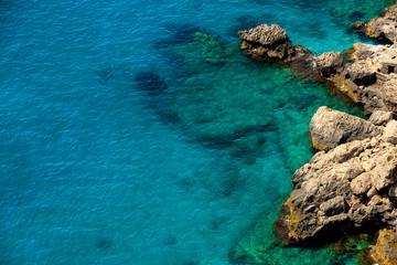 Naklejka na ściany i meble Crystal clear Water at the rocky Coast of Capri Island, Italy
