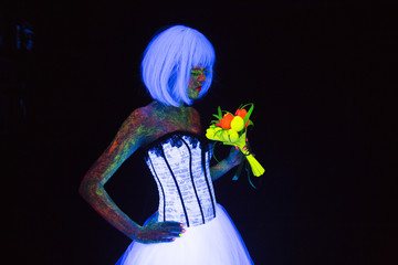concept of wedding photosession in neon lighting in vogue style bride with bouquet glows in the...