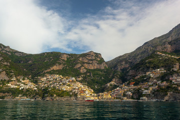 The beautiful Village of Positano at the Italian Amalfi Coast seen from the turquoise Sea on a sunny Morning