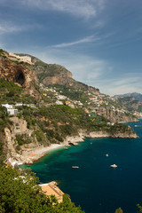 Fototapeta na wymiar View of Houses at the Amalfi Coast close to the City of Amalfi with turquoise Water on a sunny Day