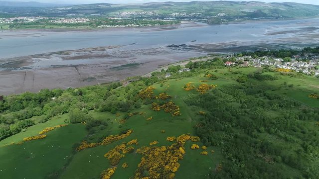 Aerial footage of the village of Langbank on the south shore of the Firth of Clyde over to Dumbarton on the far shore. 
