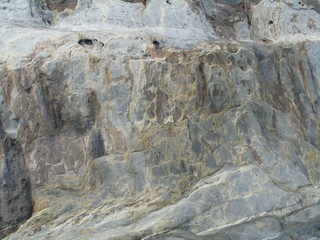textured rock surface of cliff face