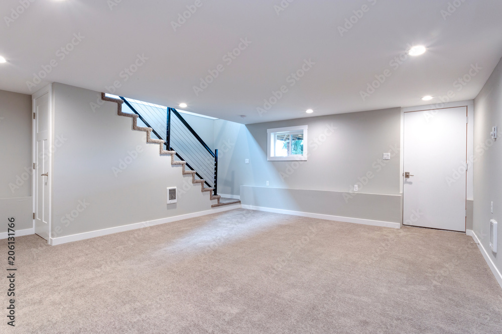 Fototapete Light spacious basement area with staircase.