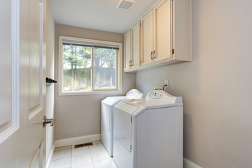 Fototapeta na wymiar Laundry room with tiled floor.