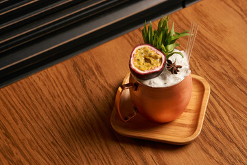 Spicy Mule cocktail on bar table. Alcoholic beverage drink with Rum angostura, reserve rum, dry orange passionfruit ,pure, pineapple pure, spice syrup ingredients, close-up
