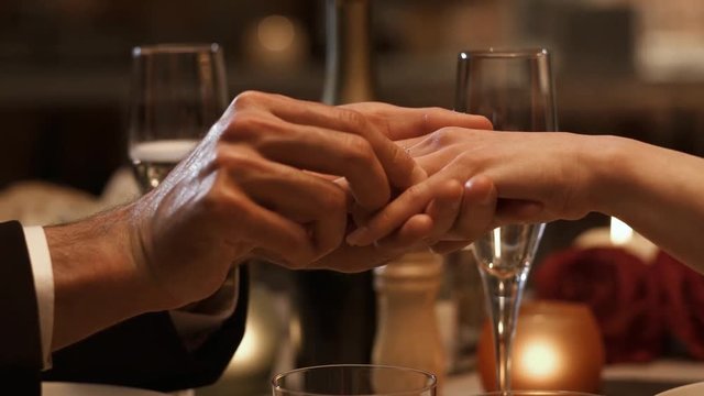 Man giving an engagement ring to his girlfriend