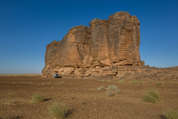 Camp with 4x4 expedition verhicle at massive rock formation – Mauritania