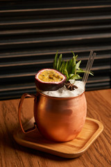 Spicy Mule cocktail on bar table. Alcoholic beverage drink with Rum angostura, reserve rum, dry orange passionfruit ,pure, pineapple pure, spice syrup ingredients, close-up