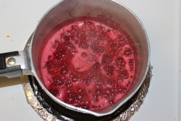 Reducing Raspberries in metal pot on stovd