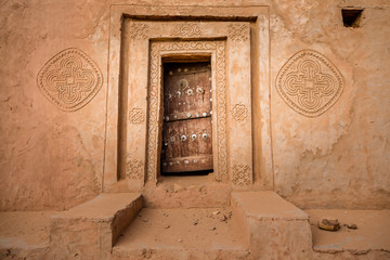 Famous ancient arabic door paintings at medieval bricked house in World Heritage Site Walata,...