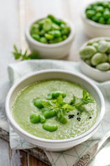 Vegetable creamy soup. Broad bean soup sprinkled with  fresh mint and nigella. Delicious and nutritious vegetarian food. Healthy eating concept.
