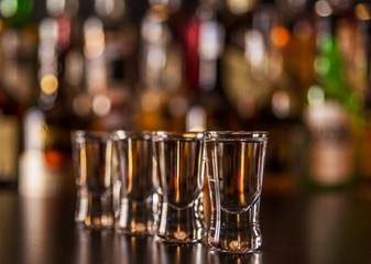 Traditional pure vodka in glasses on a black background, chilled drink