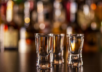 Traditional pure vodka in glasses on a black background, chilled drink