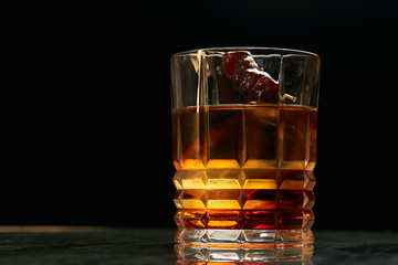 Artichoke Negroni cocktail on bar table. Tart, man's cocktail with Gin alcohol , Rosso, Cynar, close-up