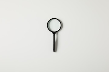 top view of single black magnifying glass with handle isolated on grey