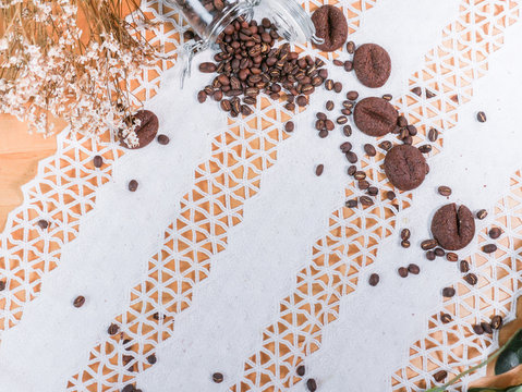 Coffee Bean And Coffee Cookies Set On Vintage Lace Tablecloth Background.