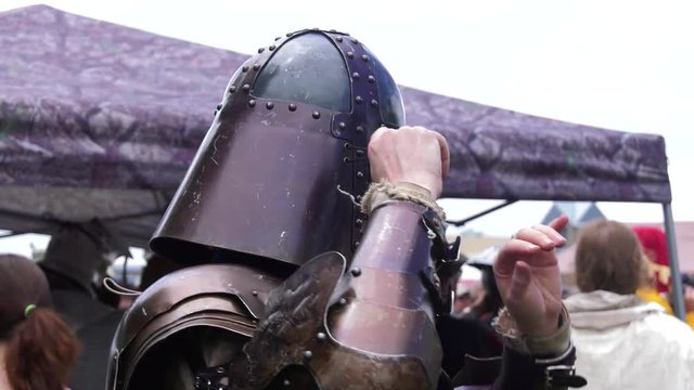 medieval warrior staps on chain mail helmet 4k slow motion