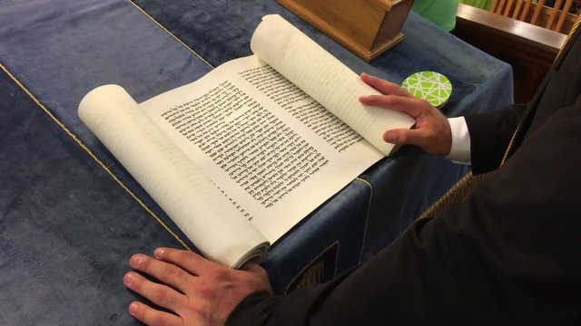 Jewish Rabbi reads The Megillah Scroll.
