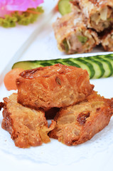 Close up of deep fried bean curd skin stuffed with kumquat