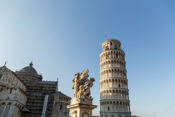 Fototapeta na wymiar Cathedral, leaning tower and angels sculpture on Square of Miracles in Pisa, Italy