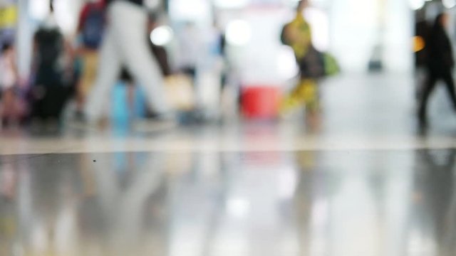Slow motion blur people or tourist or passenger walking at airport terminal - background rush travel people in airport concept