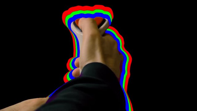 Playing with a retro vintage joystick (input device for computer games) in front of a black screen. The stick is surrounded by an RGB outline.
