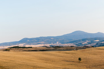 scenic view of beautiful Tuscany fields and clear blue sky, Italy
