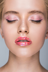 Naklejka premium attractive woman with glittering makeup with closed eyes