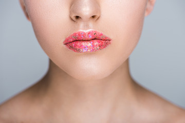 Obraz premium cropped image of woman with glitter on lips isolated on grey