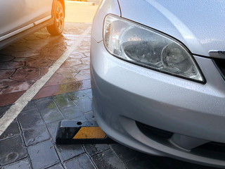 Close up front of silver car parking on road