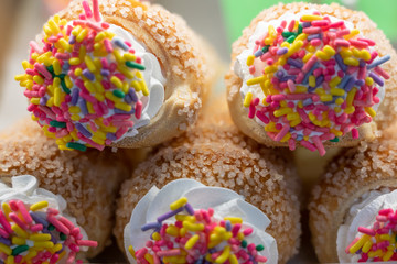 yummy fresh pastries in the bakery case with colorful bright sprinkles