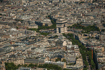 The Arc de Triomphe and buildings under blue sky, seen from the Eiffel Tower top in Paris. Known as...