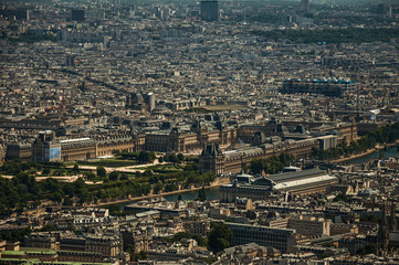 Louvre Museum, Seine River and buildings in a sunny day, seen from the Eiffel Tower top in Paris. Known as the “City of Light”, is one of the most impressive world’s cultural center. Northern France.