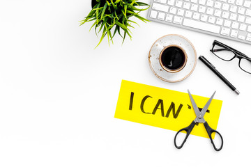 Self-doubt concept. Fight against self-doubt. Sciccors close the letter t of written word I can't....