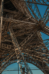 View of internal iron structure of the Eiffel Tower, with sunny blue sky in Paris. Known as the &ldquo;City of Light&rdquo;, is one of the most impressive world&rsquo;s cultural center. Northern France.