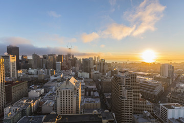 Sunrise fog above downtown San Francisco skyline and bay in California.