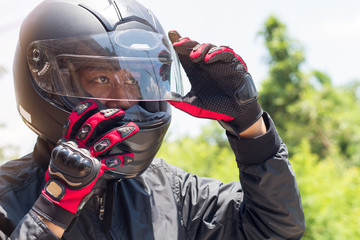 Man in a Motorcycle with helmet and gloves is an important protective clothing for motorcycling...