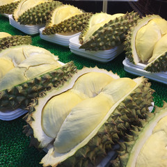 Cutting durian fruits displayed for sale in Bangkok, Thailand.