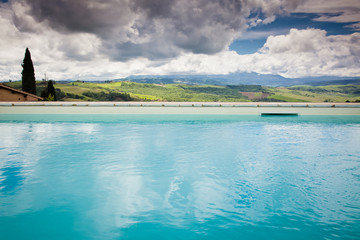 swimming pool against beautiful landscape in Tuscany