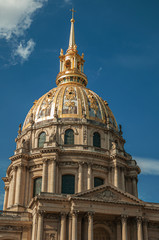 Fototapeta na wymiar Close-up of the facade and golden dome of Les Invalides Palace with a sunny blue sky at Paris. Known as the “City of Light”, is one of the most impressive world’s cultural center. Northern France.