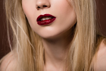 cropped shot of sensual young blonde woman with red lips