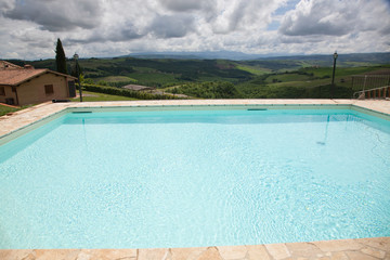 swimming pool against beautiful landscape in Tuscany