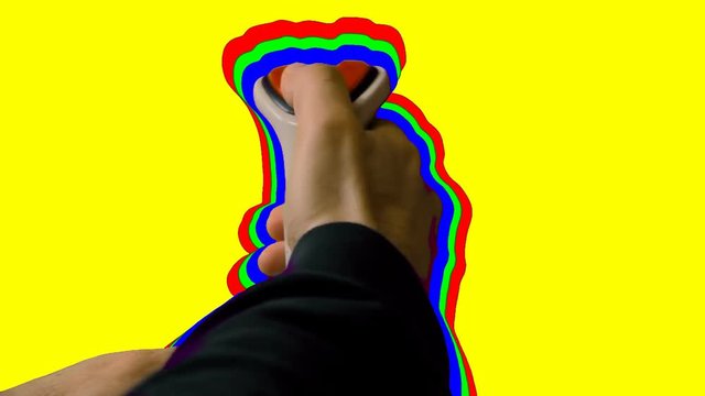 Playing with a retro vintage joystick (input device for computer games) in front of a yellow screen. The stick is surrounded by an RGB outline.

