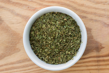 dried ocimum leaves in small bowl