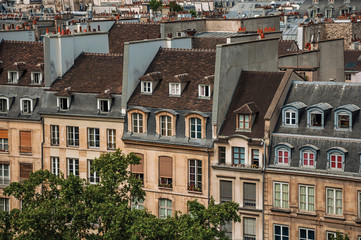Facade close-up of typical semidetached buildings seen from the Center Georges Pompidou in Paris. Known as the “City of Light”, is one of the most impressive world’s cultural center. Northern France.
