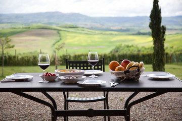 lunch with a view - table against beautiful landscape in Tuscany