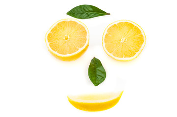 Lemon slices and green leaves in the form of a face. The concept of a healthy lifestyle.