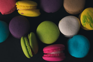 Macaroons on dark background, colorful french cookies macaroons.