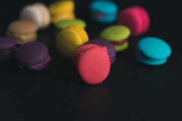 Macaroons on dark background, colorful french cookies macaroons.