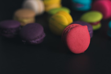 Macaroons on dark background, colorful french cookies macaroons.